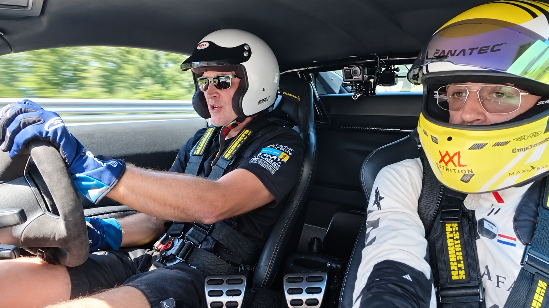 Helmeted passenger gets a full-speed Nürburgring ride