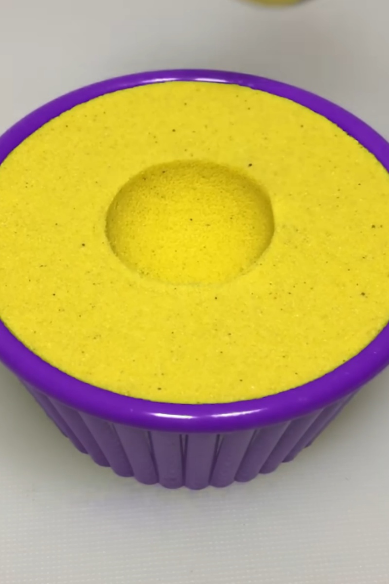 Perfect circle created in bright yellow kinetic sand