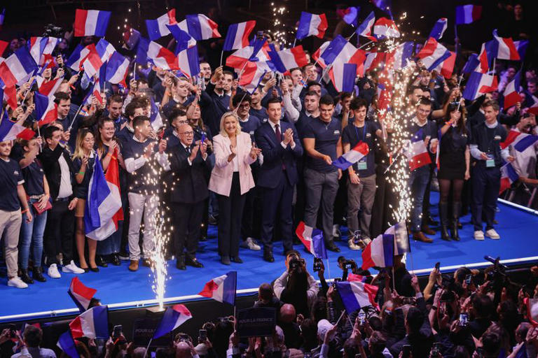 Member of parliament Eric Ciotti, president of the Union des Droites (UDR) parliamentary group and Mayor of Nice, French far-right leader Marine Le Pen, member of parliament from the French far-right Rassemblement National (National Rally - RN) party and candidate for the 2027 French presidential election, and Jordan Bardella, president of the RN party, react on stage during a political rally to launch the presidential campaign, after the party's congress in Orleans, France, October 25, 2026. REUTERS/Nicolas Economou