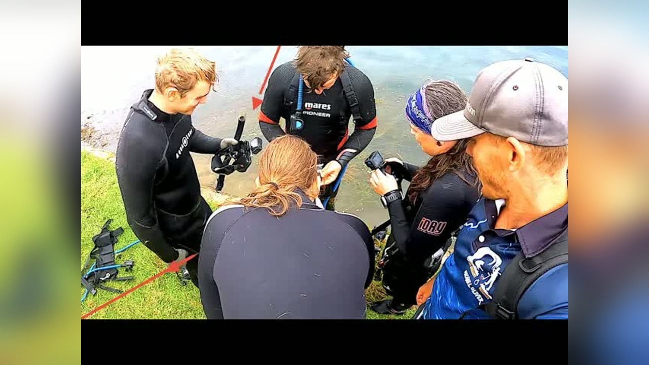Divers search an aqua park for lost jewelry