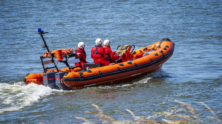What does an orange flag with a black square and circle mean in boating?