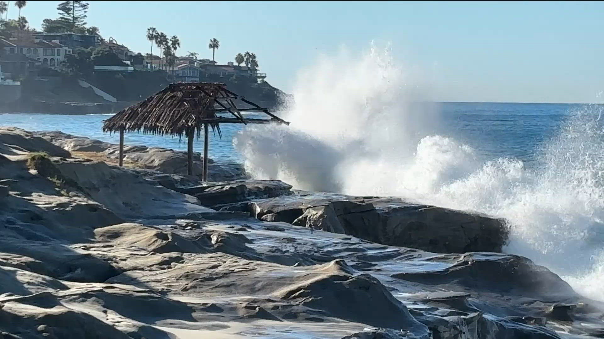 Massive waves slam into iconic Windansea Surf Shack