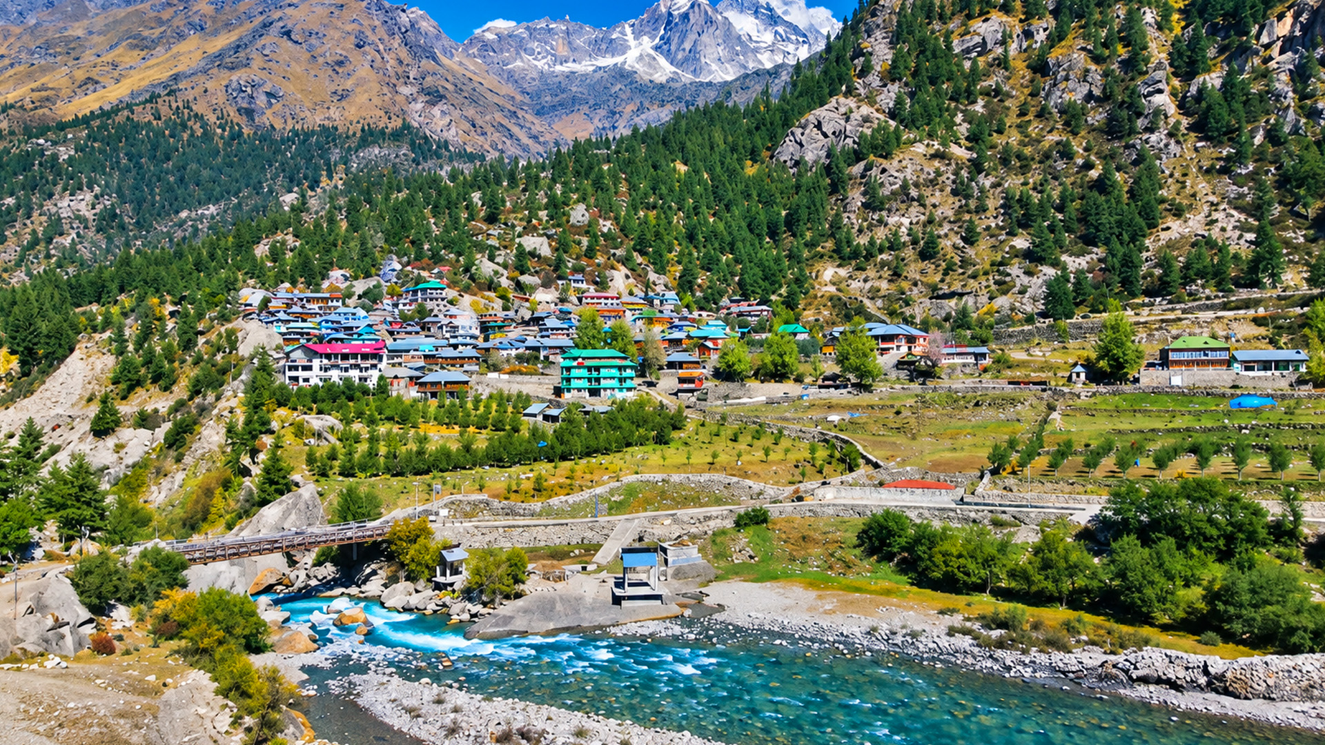 Traditional Himalayan houses stand above a mountain river