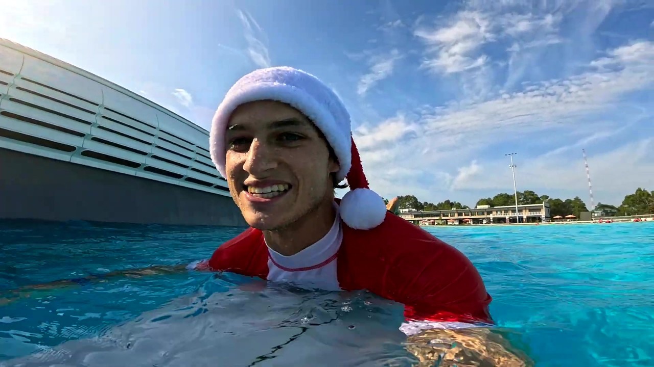 Santa hats throw off balance on a machine-built wave
