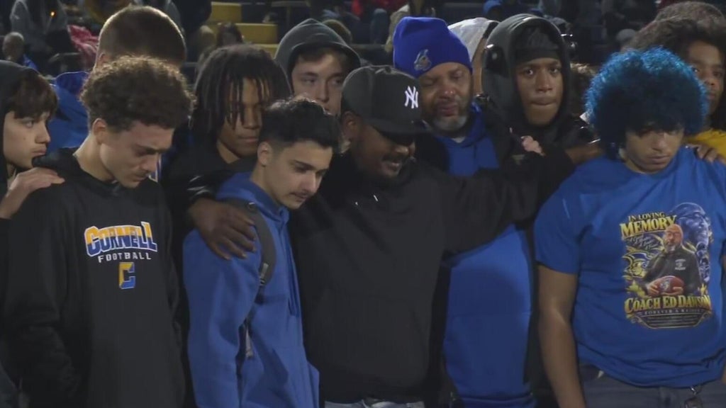Cornell school community honors football coach Ed Dawson at candlelight vigil