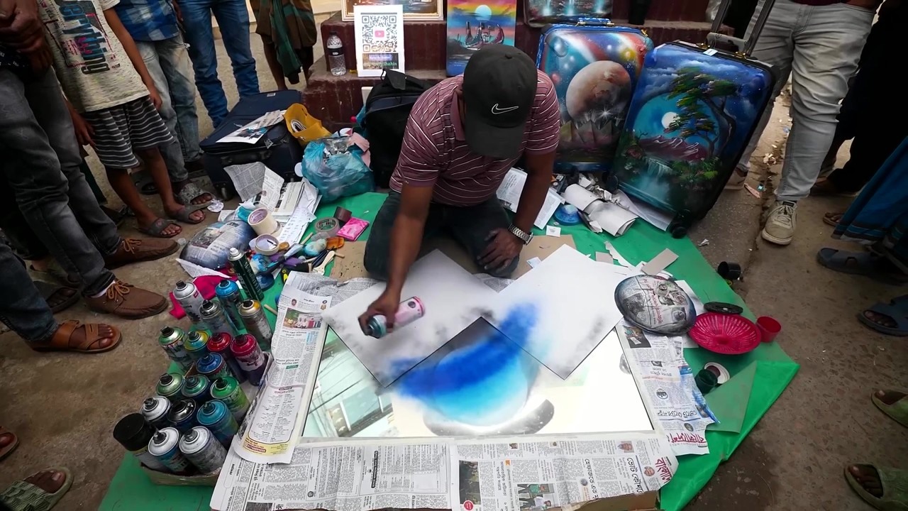A street artist spray paints in Bangladesh again