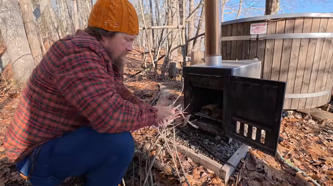 Zachary Fowler tests a homemade sail while ice fishing in Maine