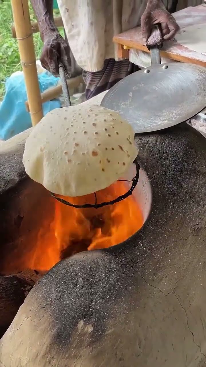 We’re in Bangladesh watching how they make street-style roti! 🫓🎈 Would ...