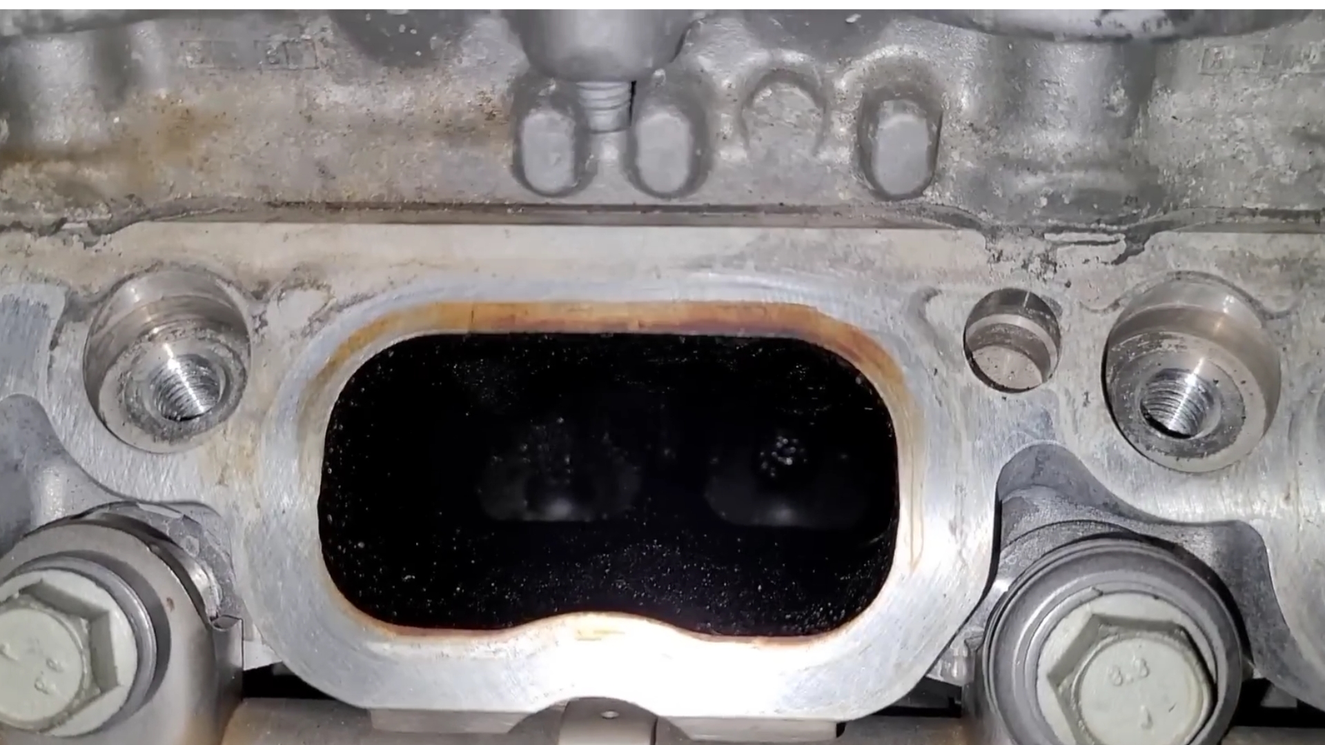 What causes carbon buildup in direct injection engines