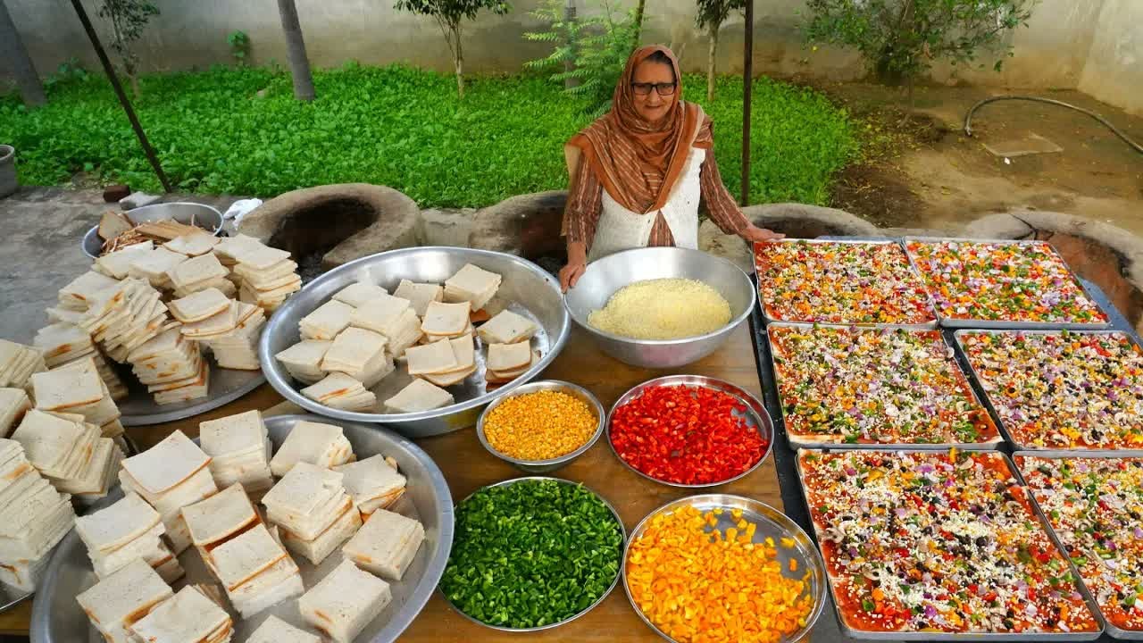 Village granny makes 500 bread pizzas in a large-scale village cooking ...