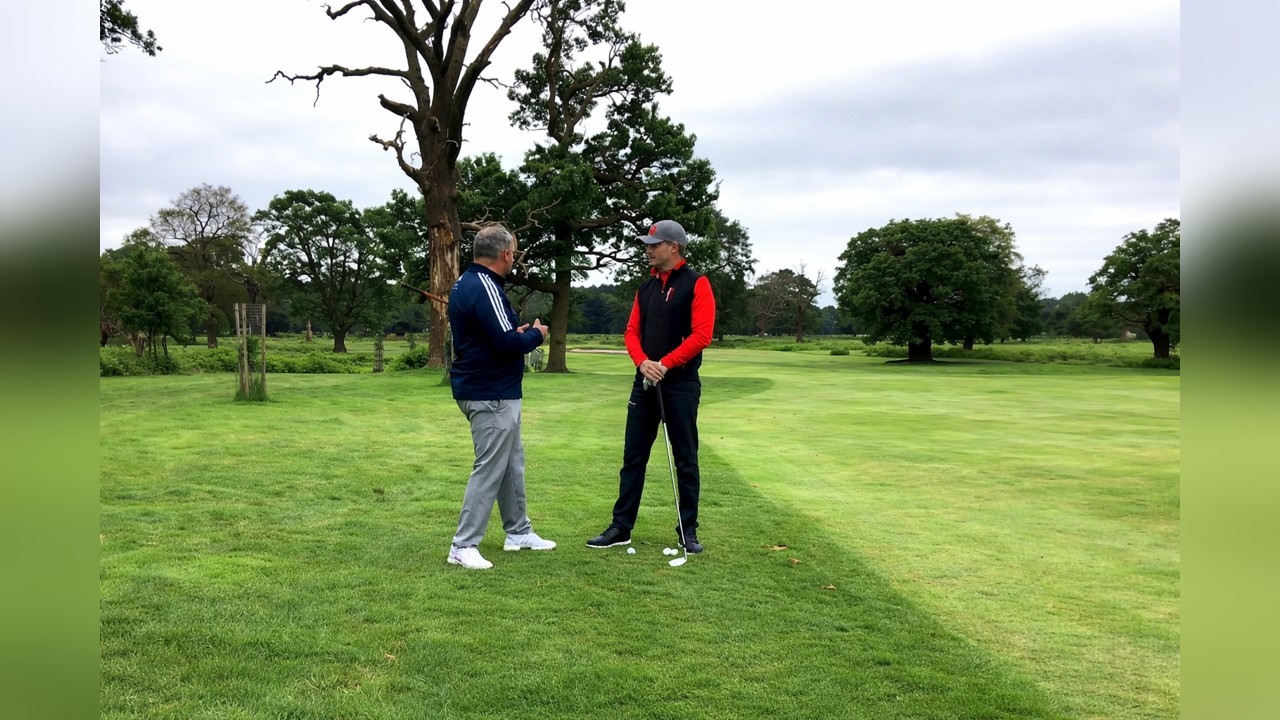 Alex Elliott teaches a golf draw around a tree