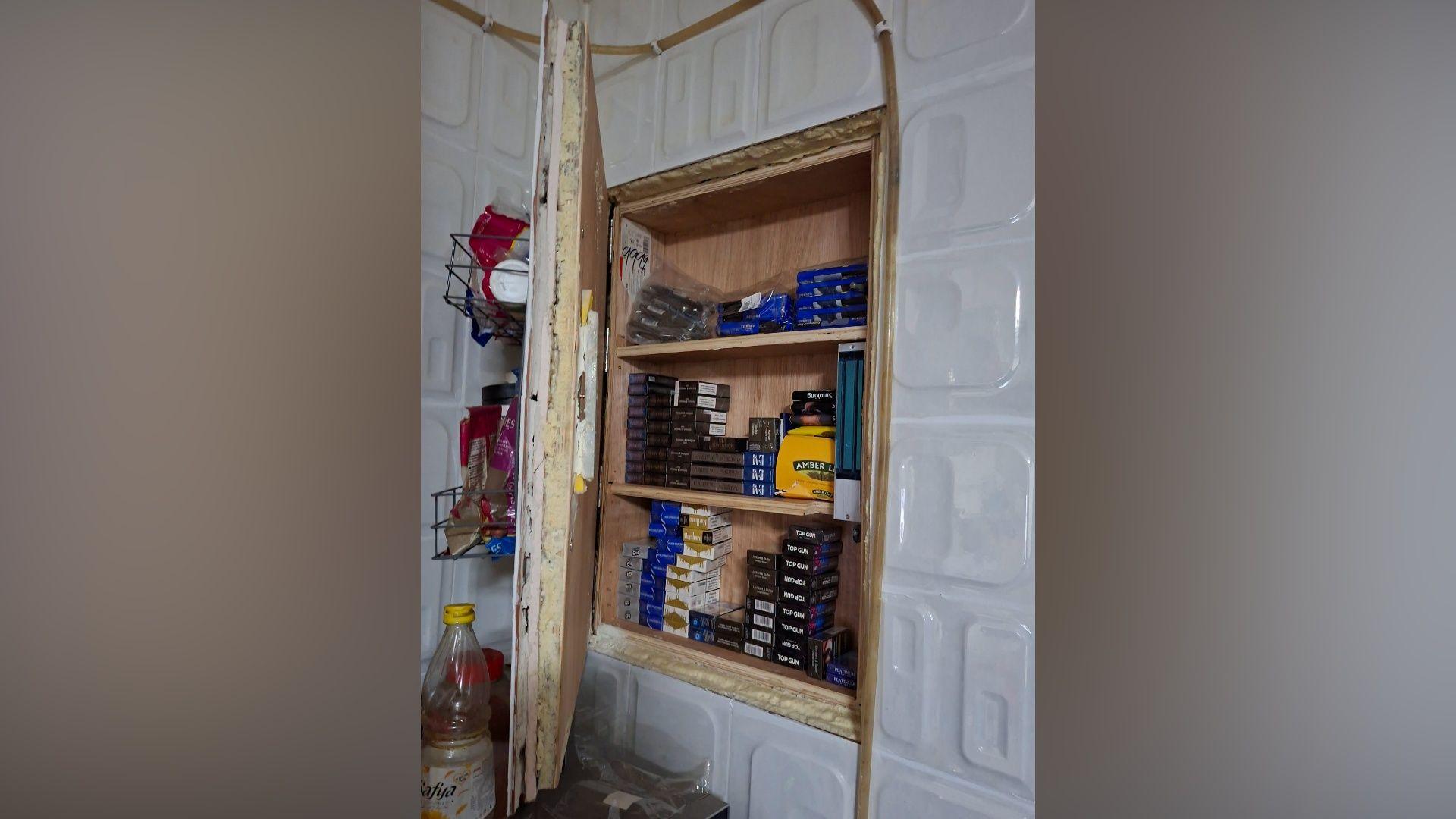 Police find illegal cigarettes hidden in shop wall