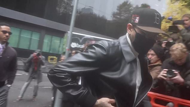 Chris Brown arrives behind a mask at London court for bottle attack ...