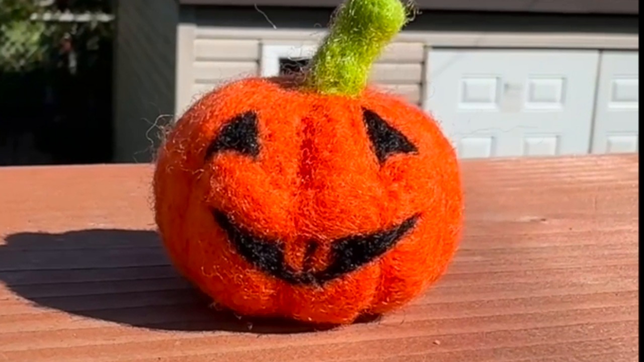 Artist makes a needle felted pumpkin from wool