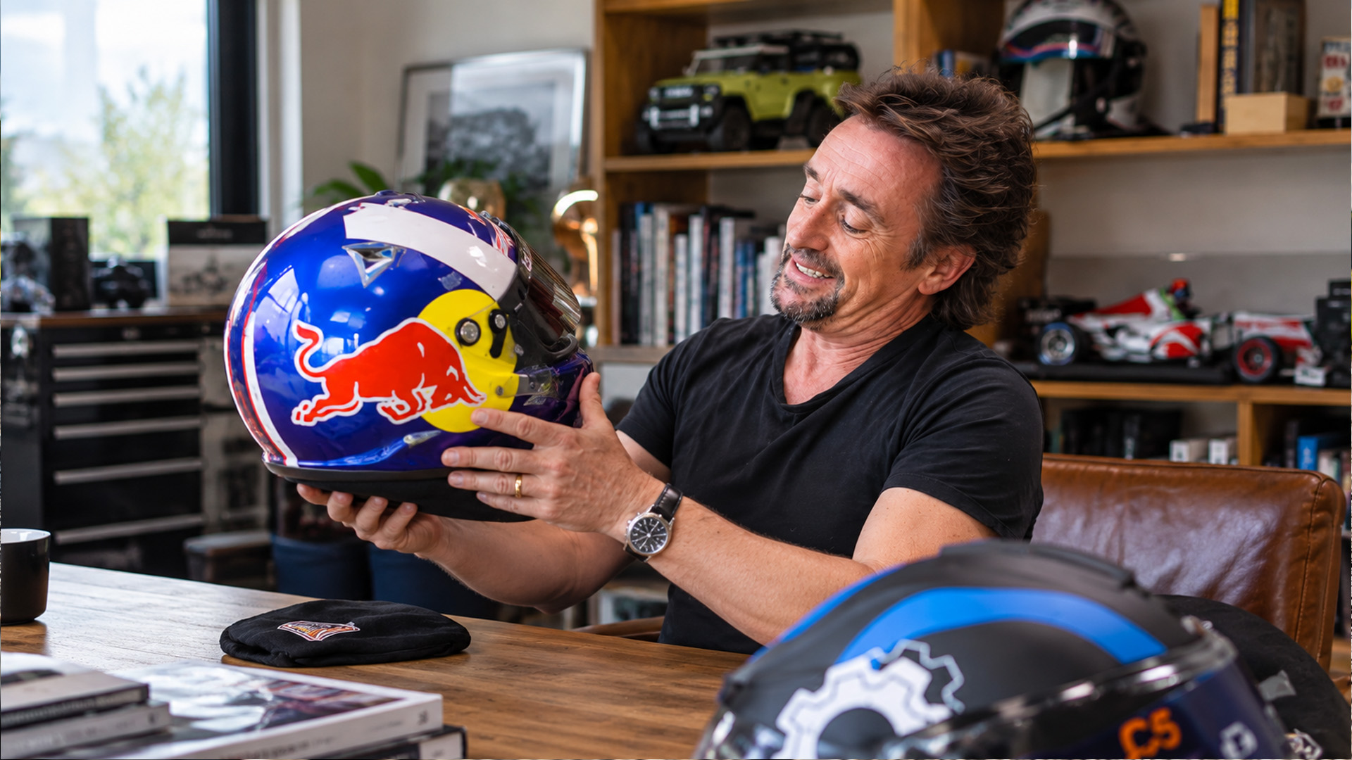 Richard Hammond receives a custom racing helmet from an F1 helmet painter