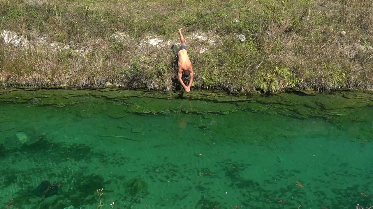 Luke dives after a pleco in a clear canal, but the fish escapes