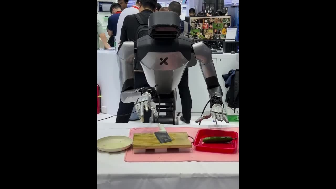 Humanoid kitchen robot slices cucumber into thin, uniform pieces in ...
