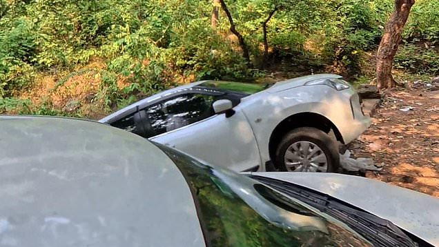 Clumsy tourists reverse car into a ditch