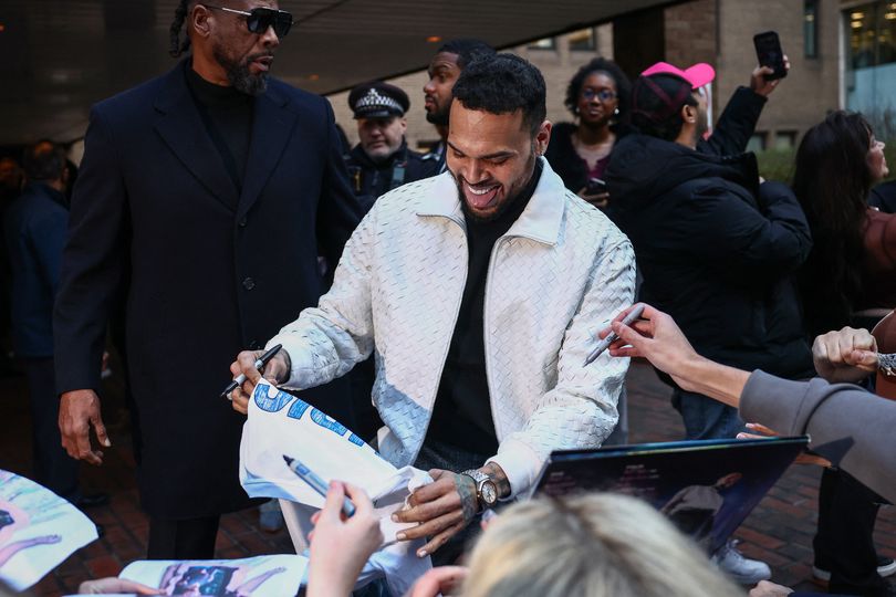 Brown signs autographs after appearing at Southwark Crown Court in January