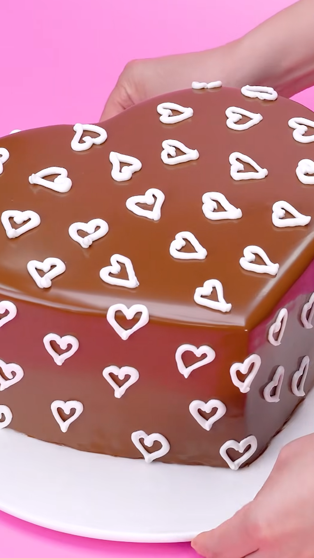 Satisfying smooth chocolate layer on a heart cake