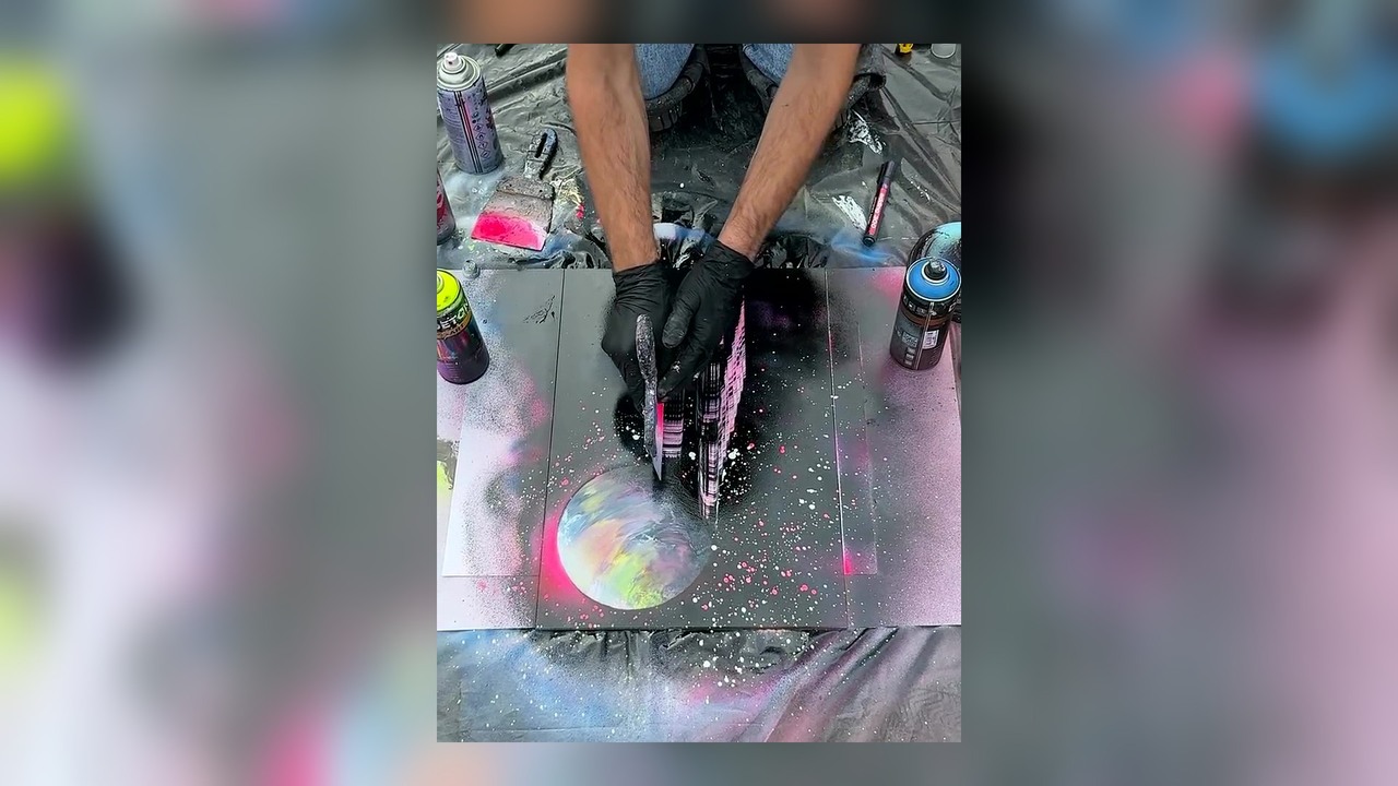 Street artist spray paints a neon city on a mirror for $20