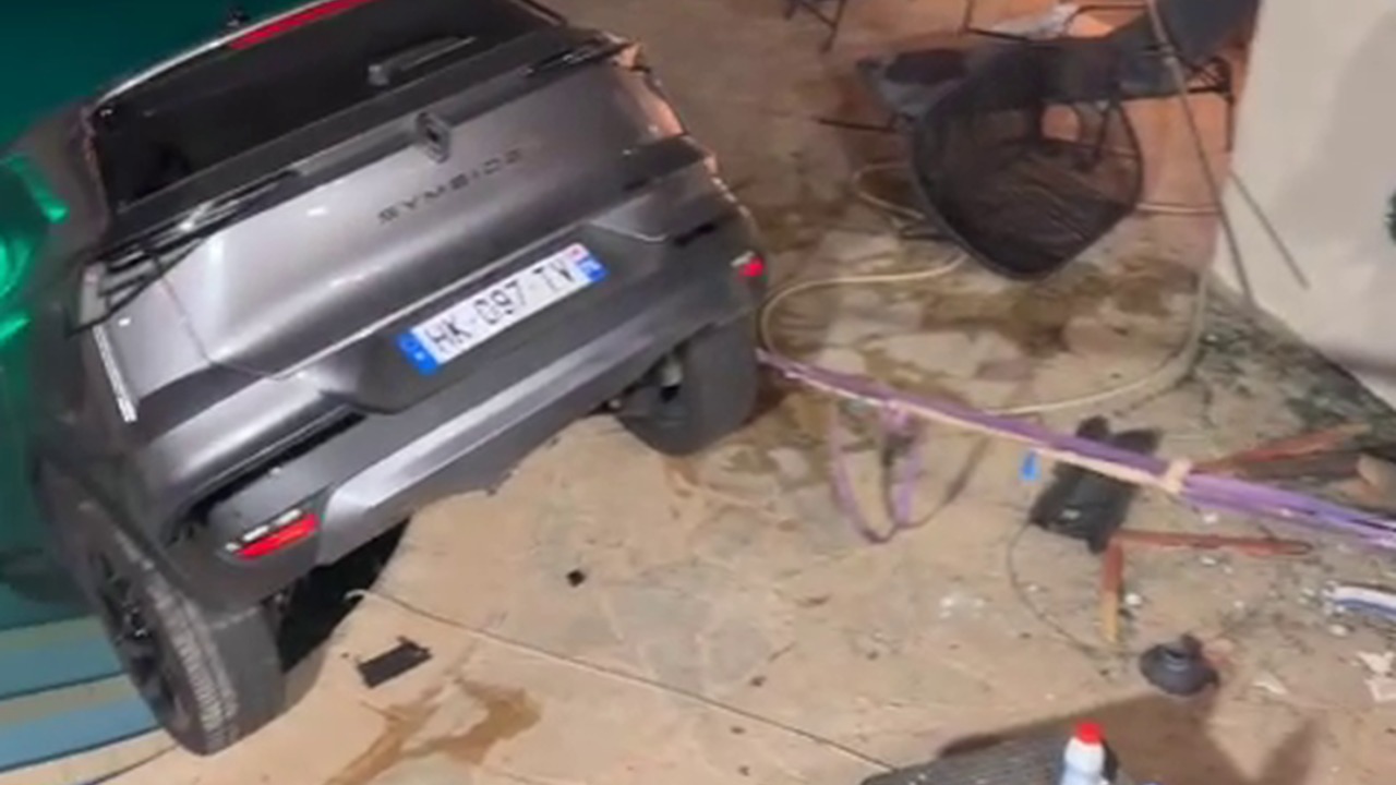 Car ends up partially submerged in swimming pool