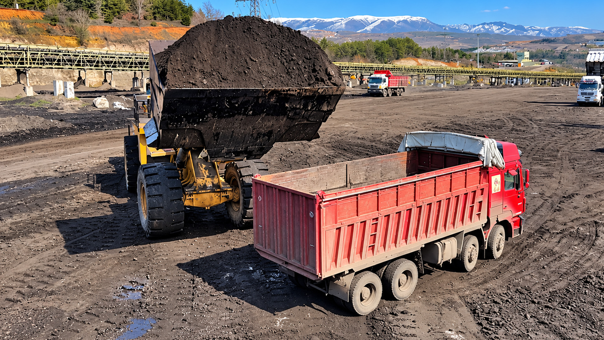 Watch a 100-ton Caterpillar loader dump a massive coal bucket in one pass