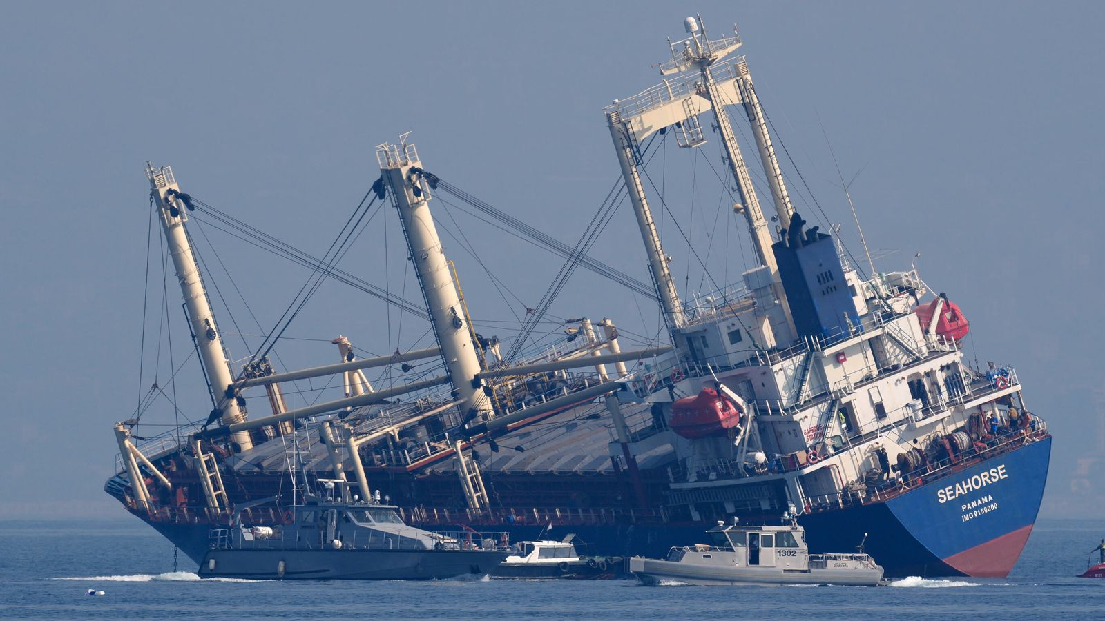 People jump overboard from drifting cargo ship