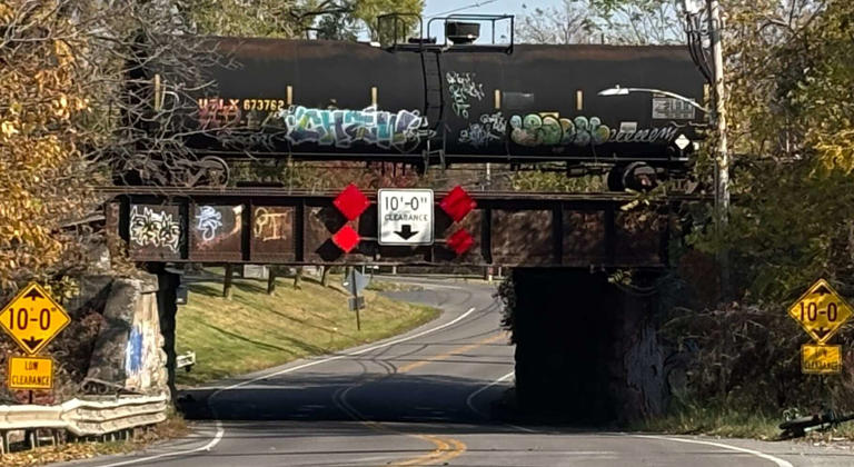 Box truck hits railroad bridge in DeWitt