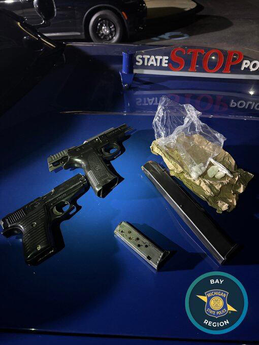 Two arrested after loaded guns, drugs found during Flint traffic stop