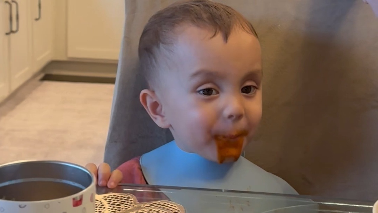 Toddler enjoys messy spaghetti dinner