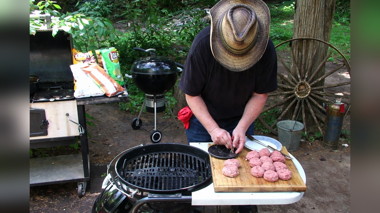 Potato chip-stuffed bacon burgers on the grill