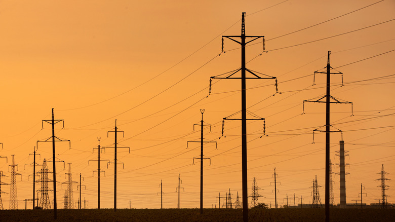 What does the yellow 'X' sign mean on top of power poles?