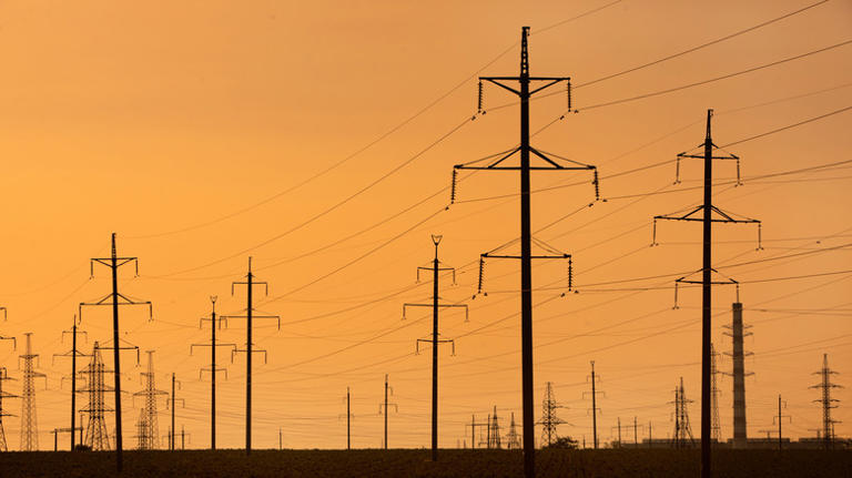 What does the yellow 'X' sign mean on top of power poles?