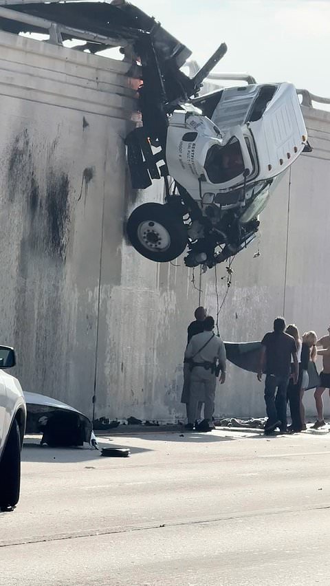 Truck driver jumps from cab dangling over California highway