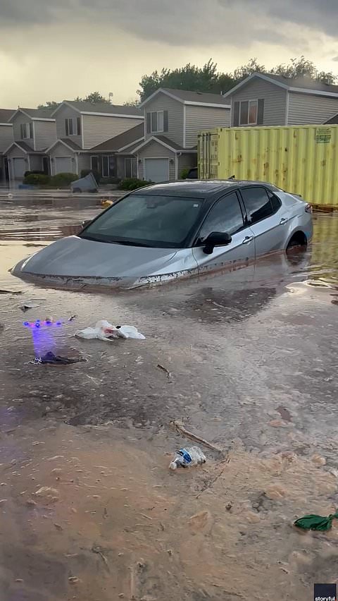 Cars and storage containers swept away by flash floods in Utah