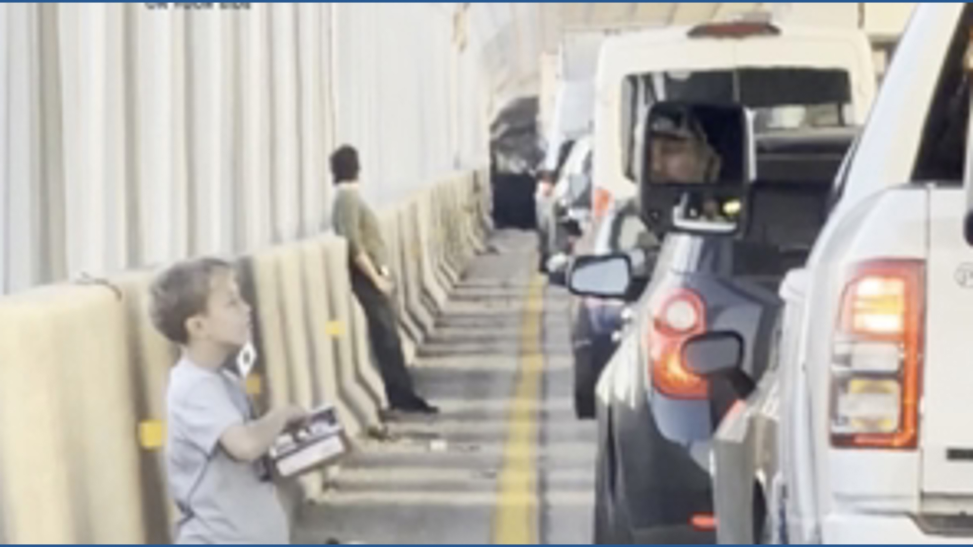 Kid sells chocolate during Sherman Minton Bridge shutdown