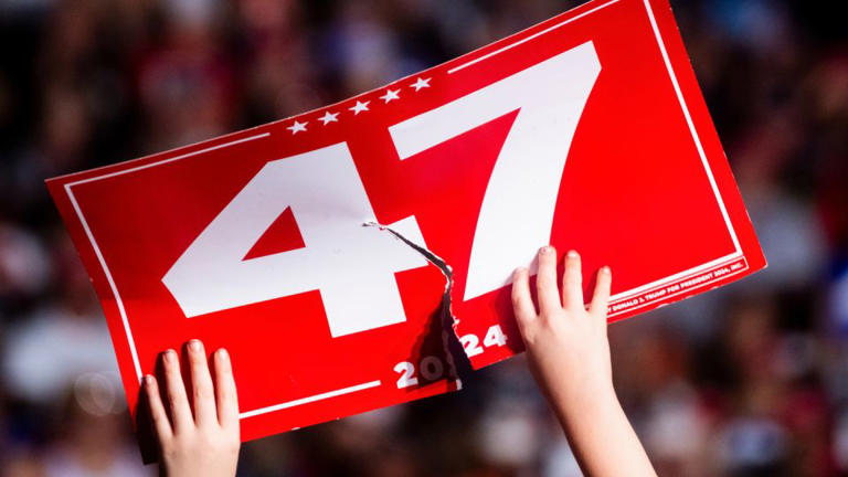 An attendee holds a ripped "47" sign during a campaign event with former US President Donald Trump, not pictured, in Greensboro, North Carolina, on October 22, 2024. - Cornell Watson/Bloomberg/Getty Images