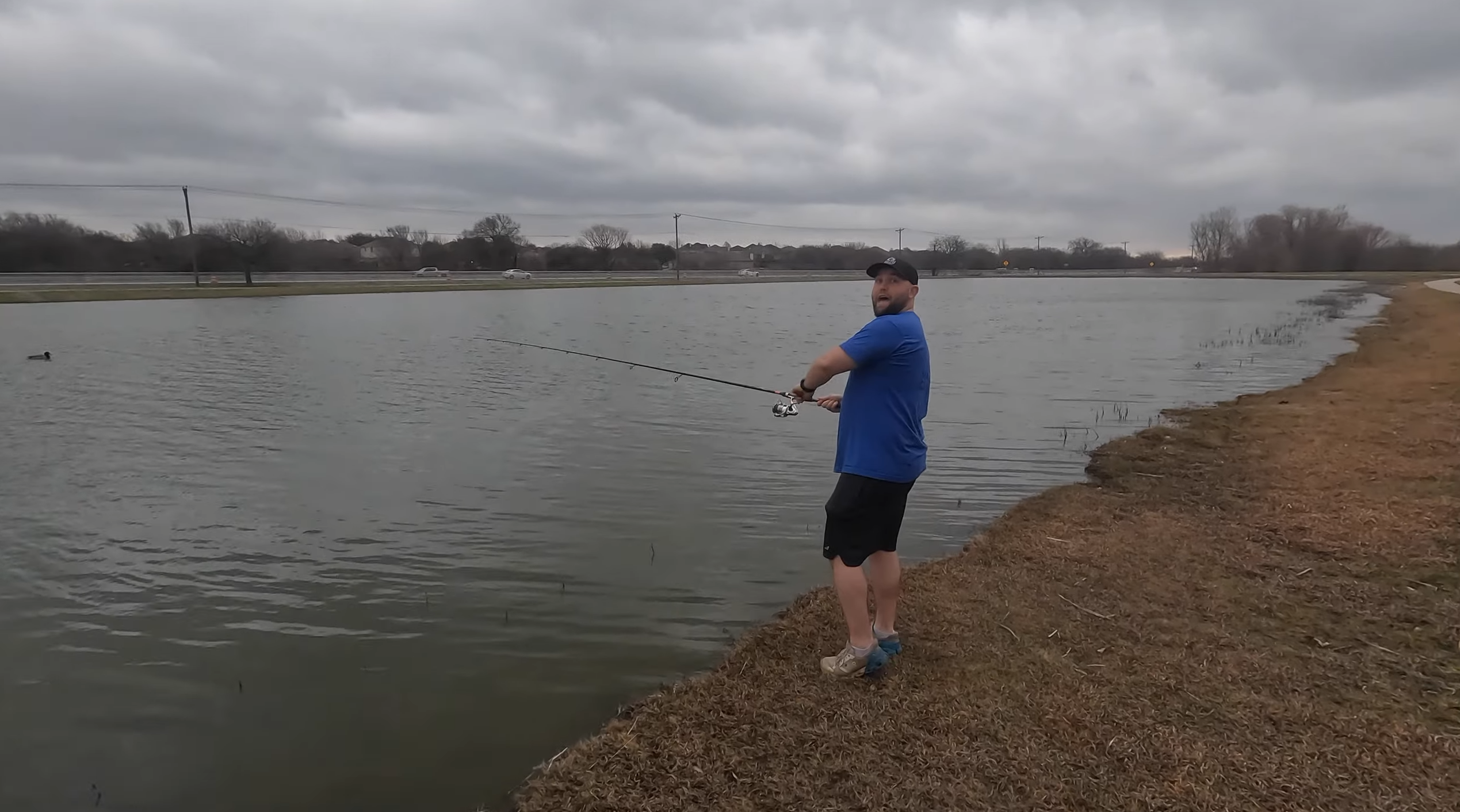 Two bass anglers fish during a storm