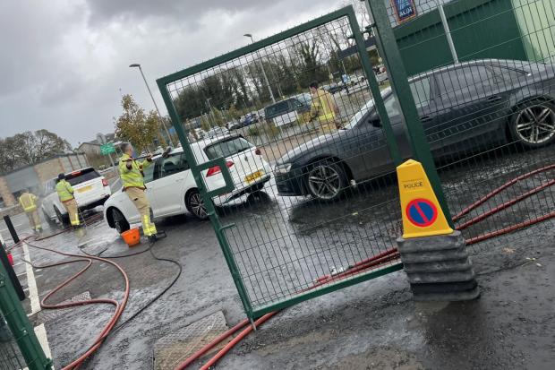 Ulverston firefighters brave bad weather for charity car wash