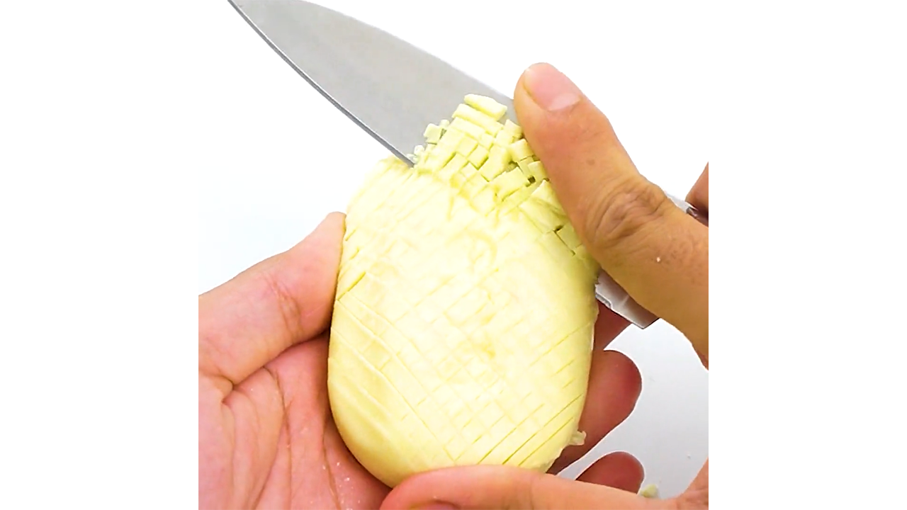 Chopping vanilla yellow soap into crisp mini tiles