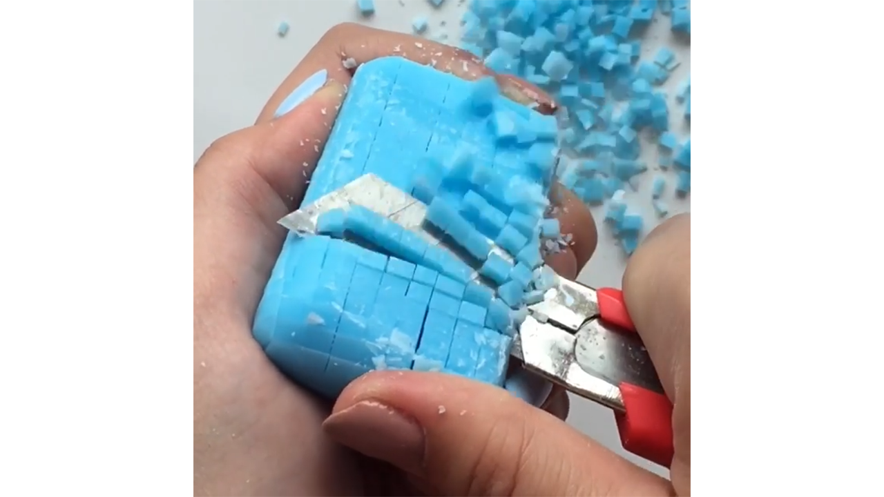 Scraping azure soap grid releasing chunky blue chips
