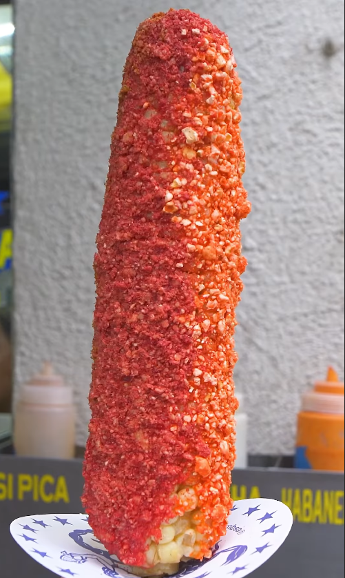 Elote corn preparation in Mexican street food