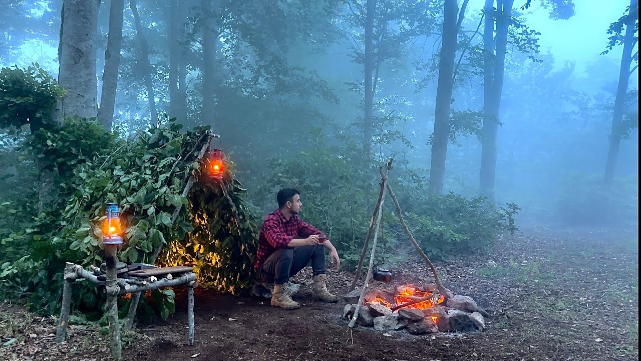 Caught in a storm - building bushcraft survival shelter - fog, strong ...