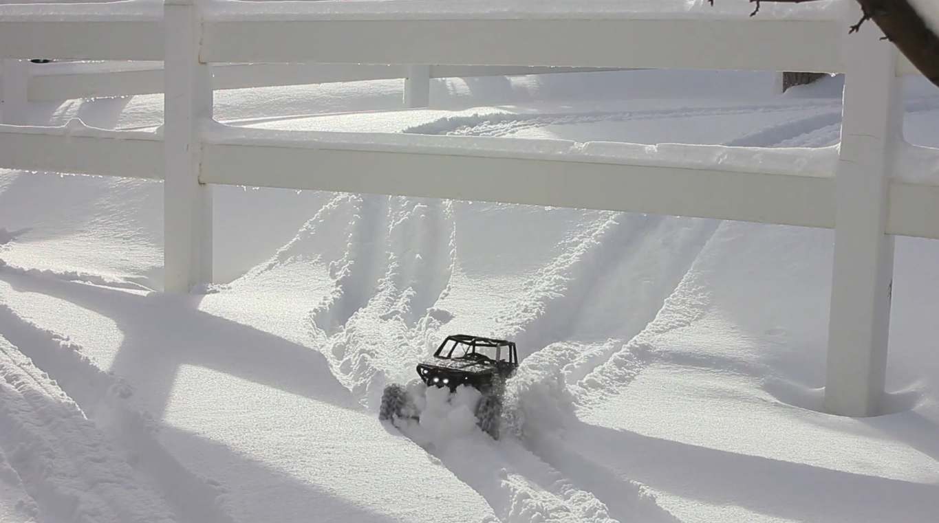 Axial Wraith RC vehicle driving in snow in slow motion