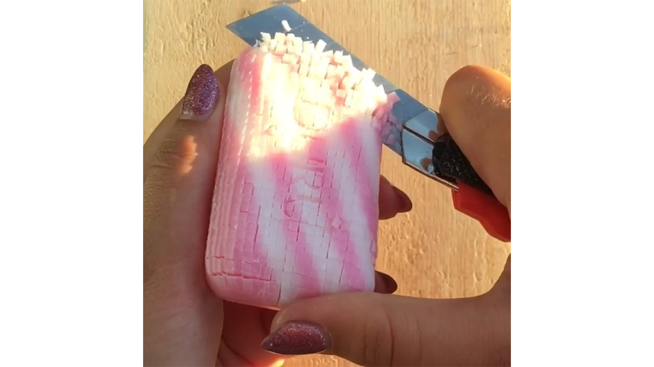 Chopping candy striped soap creating soft miniature cubes