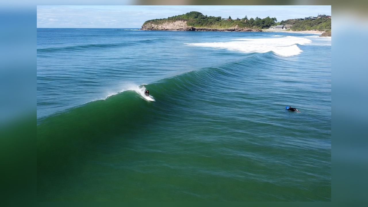 A surfer rides Sydney waves in POV and drone views