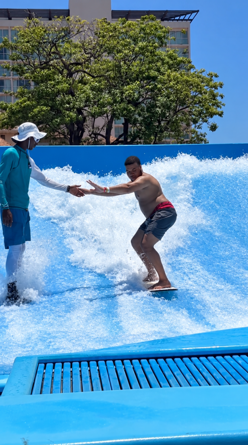 Man wipes out on surf simulator and struggles to get out