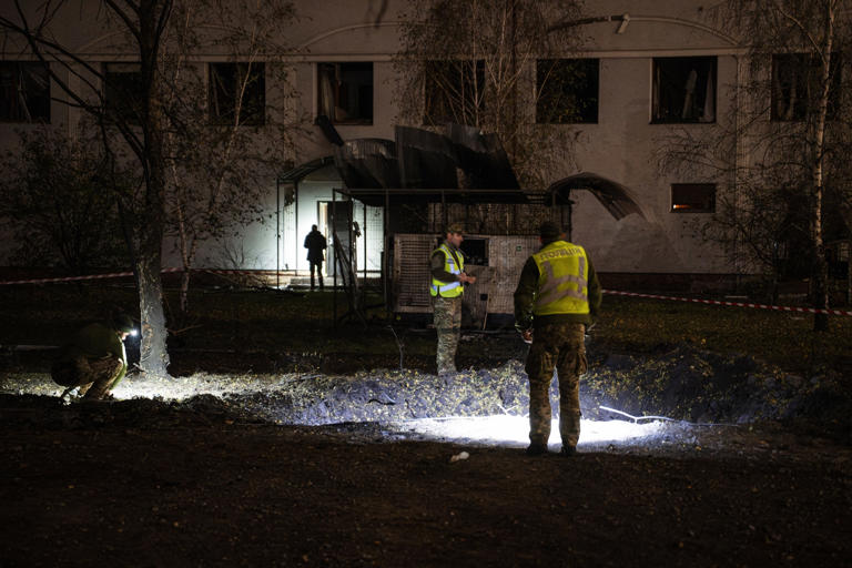 Genya Savilov/AFP via Getty Images - PHOTO: Ukrainian police officers inspect a crater on a university campus following a Russian missile strike in Kyiv, late on October 26, 2026, amid the Russian invasion of Ukraine.