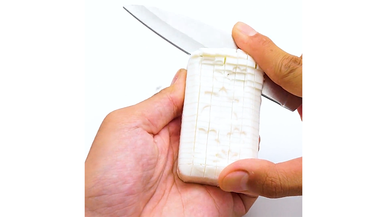 Cutting ivory soap creating a neatly spaced grid